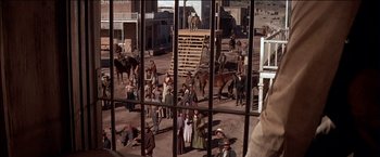 Movie still from “Pat Garrett & Billy the Kid” (1973), directed by Sam Peckinpah – A group of people standing in a dirt field; Wide shot, High angle