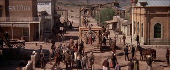 Movie still from “Pat Garrett & Billy the Kid” (1973), directed by Sam Peckinpah – A crowd of people standing around a wooden structure; Extreme Wide shot, High angle