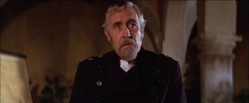 Movie still from “Pat Garrett & Billy the Kid” (1973), directed by Sam Peckinpah – An older man in a military uniform looking at the camera; Close Up shot, Low angle