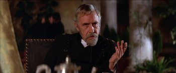 Movie still from “Pat Garrett & Billy the Kid” (1973), directed by Sam Peckinpah – An older man in a military uniform is sitting at a table; Close Up shot, Over the shoulder angle