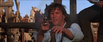 Movie still from “Pat Garrett & Billy the Kid” (1973), directed by Sam Peckinpah – A man holding a gun in his hand; Close Up shot, Low angle