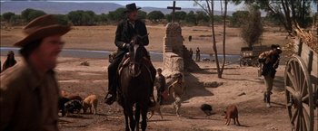 Movie still from “Pat Garrett & Billy the Kid” (1973), directed by Sam Peckinpah – A man riding a horse in a desert area; Wide shot, Low angle