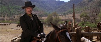 Movie still from “Pat Garrett & Billy the Kid” (1973), directed by Sam Peckinpah – A man sitting on top of a brown horse; Medium shot, Low angle