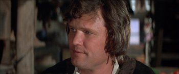 Movie still from “Pat Garrett & Billy the Kid” (1973), directed by Sam Peckinpah – A person with long brown hair; Close Up shot, Low angle