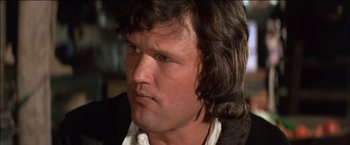 Movie still from “Pat Garrett & Billy the Kid” (1973), directed by Sam Peckinpah – A person with long brown hair; Close Up shot, Low angle