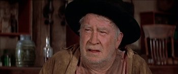 Movie still from “Pat Garrett & Billy the Kid” (1973), directed by Sam Peckinpah – An old man with a beard wearing a cowboy hat; Close Up shot, Over the shoulder angle