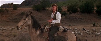 Movie still from “Pat Garrett & Billy the Kid” (1973), directed by Sam Peckinpah – A man sitting on top of a brown horse; Medium shot, Low angle