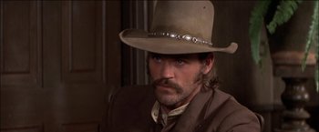 Movie still from “Pat Garrett & Billy the Kid” (1973), directed by Sam Peckinpah – A man in a cowboy hat with a long beard; Close Up shot, Low angle