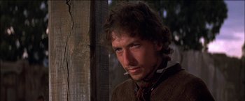 Movie still from “Pat Garrett & Billy the Kid” (1973), directed by Sam Peckinpah – A person wearing a tie; Close Up shot, Over the shoulder angle