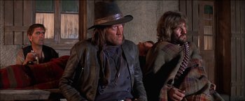 Movie still from “Pat Garrett & Billy the Kid” (1973), directed by Sam Peckinpah – A man wearing a hat and a leather jacket; Medium shot, Low angle