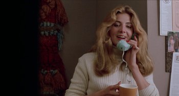 Movie still from “Patty Hearst” (1988), directed by Paul Schrader – A woman talking on a phone while holding a cup of coffee; Close Up shot, Low angle