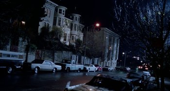 Movie still from “Patty Hearst” (1988), directed by Paul Schrader – Cars parked on the side of the street at night; Extreme Wide shot, High angle