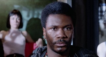 Movie still from “Patty Hearst” (1988), directed by Paul Schrader – A person wearing a jacket; Close Up shot, Low angle