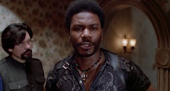 Movie still from “Patty Hearst” (1988), directed by Paul Schrader – A person wearing a necklace; Close Up shot, Low angle