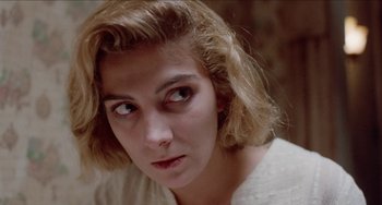 Movie still from “Patty Hearst” (1988), directed by Paul Schrader – A person wearing a white shirt; Close Up shot, High angle