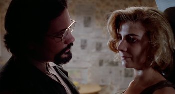 Movie still from “Patty Hearst” (1988), directed by Paul Schrader – A man and a woman looking at one another; Close Up shot, Over the shoulder angle