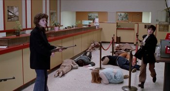 Movie still from “Patty Hearst” (1988), directed by Paul Schrader – A group of people laying on the ground in a room; Wide shot, High angle
