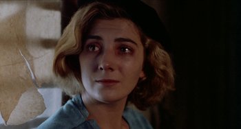 Movie still from “Patty Hearst” (1988), directed by Paul Schrader – A person wearing a hat; Close Up shot, Over the shoulder angle