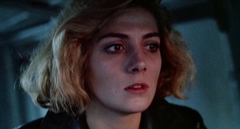 Movie still from “Patty Hearst” (1988), directed by Paul Schrader – A person wearing a leather jacket; Close Up shot, Low angle