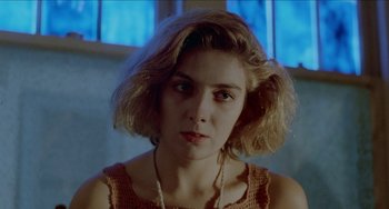 Movie still from “Patty Hearst” (1988), directed by Paul Schrader – A person wearing a necklace; Close Up shot, Low angle