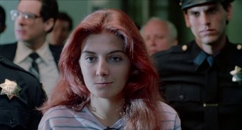 Movie still from “Patty Hearst” (1988), directed by Paul Schrader – A person with long red hair; Close Up shot, Over the shoulder angle