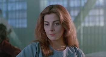 Movie still from “Patty Hearst” (1988), directed by Paul Schrader – A person with long red hair; Close Up shot, Low angle