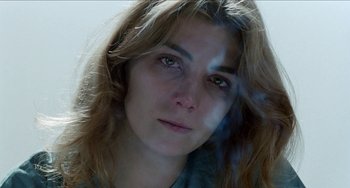 Movie still from “Patty Hearst” (1988), directed by Paul Schrader – A person with long hair; Close Up shot, Low angle