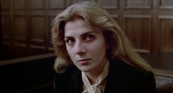 Movie still from “Patty Hearst” (1988), directed by Paul Schrader – A person wearing a suit and tie; Close Up shot, High angle