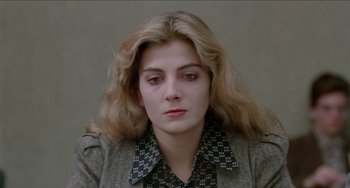 Movie still from “Patty Hearst” (1988), directed by Paul Schrader – A woman with long blonde hair wearing a gray jacket; Close Up shot, High angle