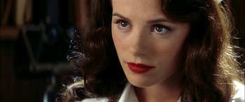 A person wearing a white shirt and red lipstick