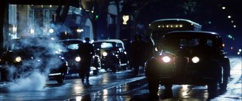 Movie still from “Pearl Harbor” (2001), directed by Michael Bay – A group of people walking down a street at night; Wide shot, Low angle