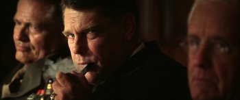 Movie still from “Pearl Harbor” (2001), directed by Michael Bay – A person wearing a suit and tie; Close Up shot, Low angle