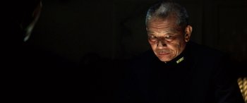 Movie still from “Pearl Harbor” (2001), directed by Michael Bay – An older man in a black shirt is looking at the camera; Close Up shot, Low angle