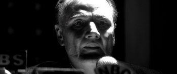 Movie still from “Pearl Harbor” (2001), directed by Michael Bay – A black and white photo of a man with a microphone; Close Up shot, Low angle