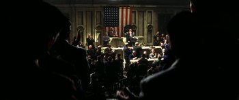 Movie still from “Pearl Harbor” (2001), directed by Michael Bay – A group of people sitting in front of an american flag; Extreme Wide shot, High angle