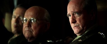 Movie still from “Pearl Harbor” (2001), directed by Michael Bay – Two older men sitting next to each other in the dark; Close Up shot, Over the shoulder angle