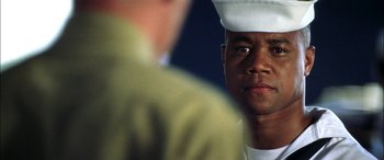 Movie still from “Pearl Harbor” (2001), directed by Michael Bay – A man wearing a white hat; Close Up shot, Over the shoulder angle