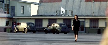 Movie still from “Pearl Harbor” (2001), directed by Michael Bay – A woman in a black dress walking in a parking lot; Wide shot, Low angle