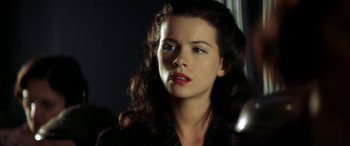 Movie still from “Pearl Harbor” (2001), directed by Michael Bay – A beautiful woman with long dark curly hair and red lipstick; Close Up shot, Low angle