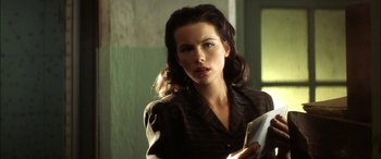 Movie still from “Pearl Harbor” (2001), directed by Michael Bay – A beautiful woman holding a piece of paper in a room; Close Up shot, Low angle