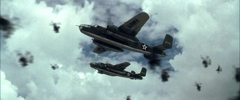 Movie still from “Pearl Harbor” (2001), directed by Michael Bay – Two military planes flying in the sky with smoke coming out of them; Wide shot, Low angle