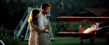 Movie still from “Pearl Harbor” (2001), directed by Michael Bay – A man and a woman standing next to each other in a field; Medium shot, Low angle