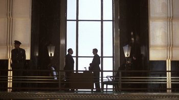 Movie still from “Pennies from Heaven” (1981), directed by Herbert Ross – Two men are standing in front of a large window; Wide shot, Low angle