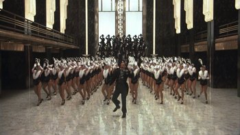 Movie still from “Pennies from Heaven” (1981), directed by Herbert Ross – A group of women in black and white outfits and a man in a black uniform; Extreme Wide shot, High angle