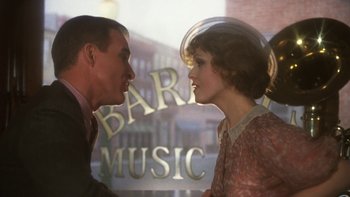 Movie still from “Pennies from Heaven” (1981), directed by Herbert Ross – A man and a woman face to face in front of a bar; Medium shot, Over the shoulder angle