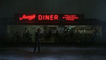 Movie still from “Pennies from Heaven” (1981), directed by Herbert Ross – A man standing in front of a diner at night; Extreme Wide shot, Low angle