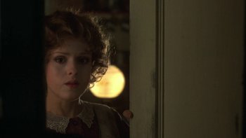 Movie still from “Pennies from Heaven” (1981), directed by Herbert Ross – A young woman standing in front of an open door; Close Up shot, Over the shoulder angle
