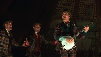 Movie still from “Pennies from Heaven” (1981), directed by Herbert Ross – Two men in suits and hats are playing a banjo; Medium shot, Low angle