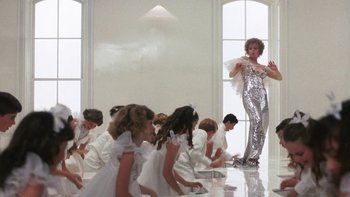 Movie still from “Pennies from Heaven” (1981), directed by Herbert Ross – A group of people in white dresses and a woman in silver; Wide shot, Low angle