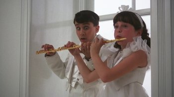 Movie still from “Pennies from Heaven” (1981), directed by Herbert Ross – Two young children in white outfits playing a flute; Close Up shot, Low angle